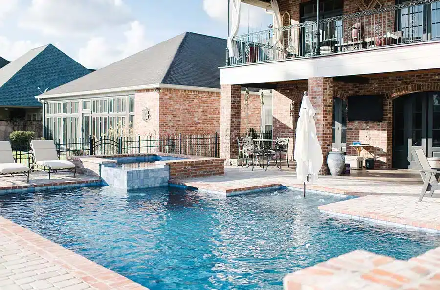 Completed pool and spa beside a brick outdoor living area